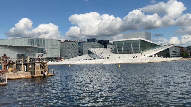 Recreational saunas and modern architectural buildings align the waterfront in downtown Oslo, Norway