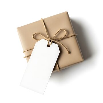 A simple brown paper wrapped gift box with twine and a blank white tag isolated on white background