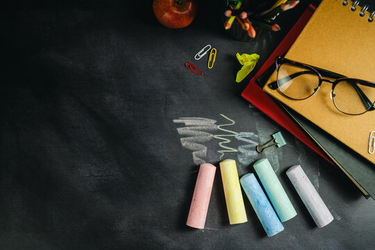 Educational chalkboard layout with colorful chalk and school supplies, classroom mockup