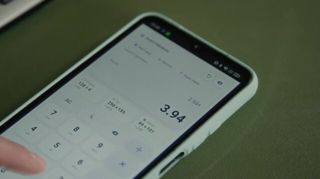Young adult tapping screen of smartphone to calculate monthly budget, household utility bills and expenses. Footage is perfect for student loan, personal finance, and mobile banking advertisements