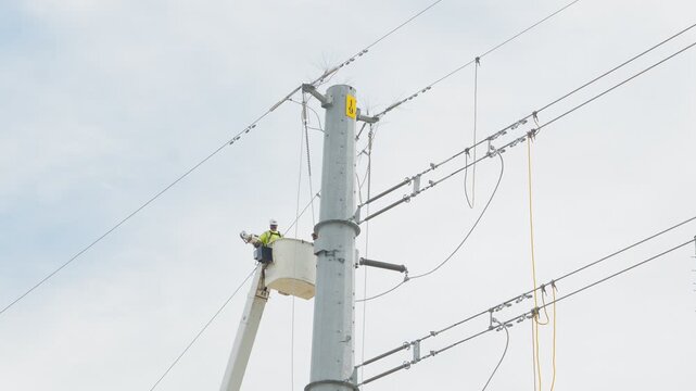 Electrical power linemen in bucket lift