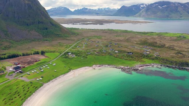 Discover Lofoten Island in Norway, featuring beautiful landscapes, camping site on Hov Beach, and dramatic mountains near the shore. Experience the natural beauty of this remarkable area.