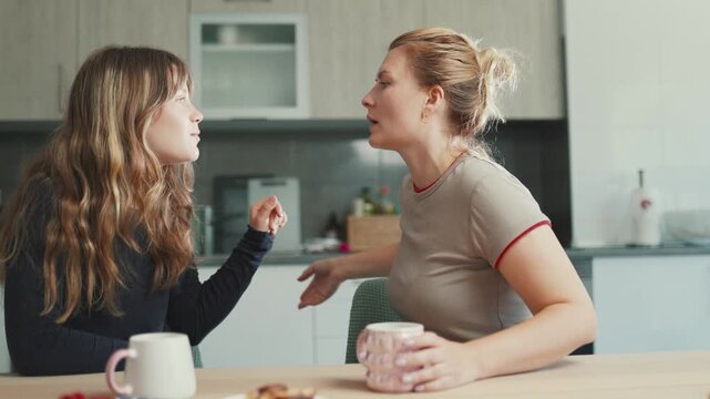 Mother and daughter having an animated conversation at home