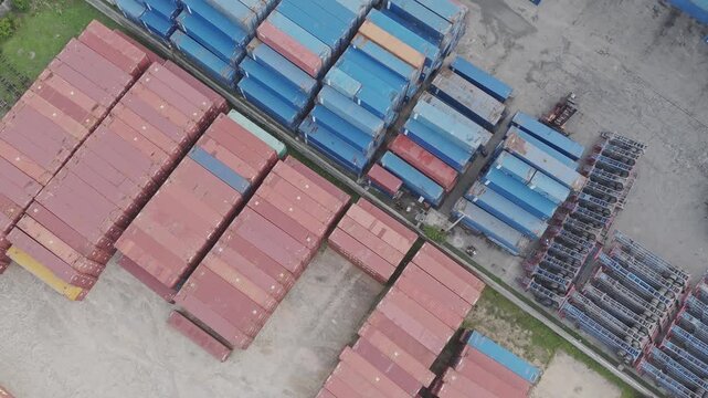 Top Down Aerial View of Stacking Intermodal Cargo Containers in a Port Terminal