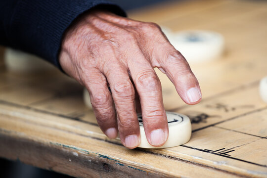 Old man playing traditional chinese chess, Beijing, China
