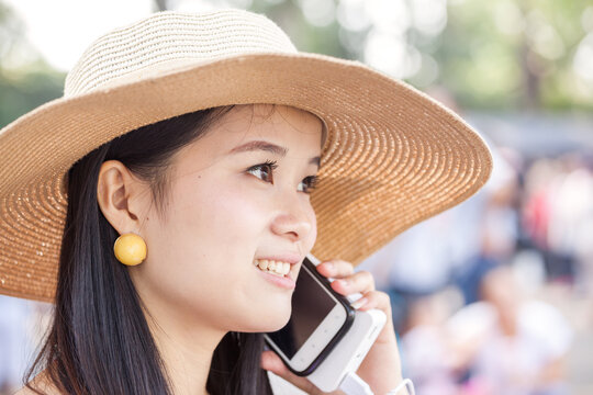 Young chinese woman using smartphone outdoors, Beijing, China