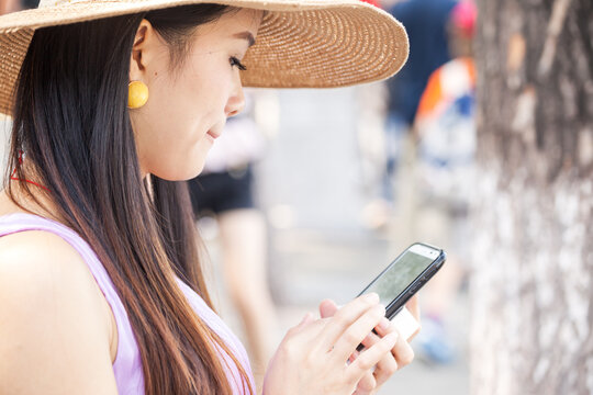 Chinese woman messaging on smartphone with copy space, Beijing, China