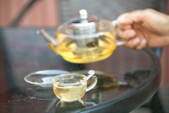 Traditional Chinese green tea served in a pot and cup on a wooden table, Pingyao, Shanxi, China.