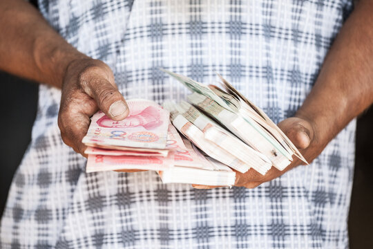 Close up of hands holding money, Turpan, Xinjiang, China
