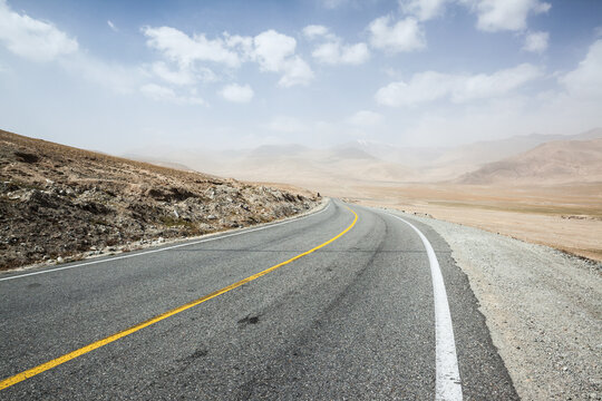Deserted road through high mountains of central Asia, Karakul, Xinjiang, China