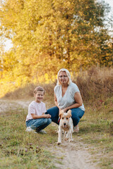 Fototapeta premium Mother, daughter and dog on forest path