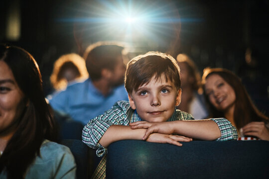 Boy watching a movie in a cinema theater