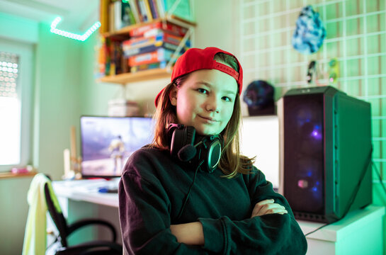 Confident teen gamer with headset in home gaming room