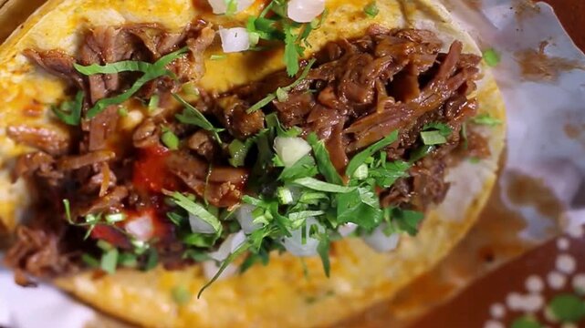 Authentic Mexican beef birria tacos with fresh cilantro and onions, traditional street food tacos on corn tortillas, slow cooked shredded meat