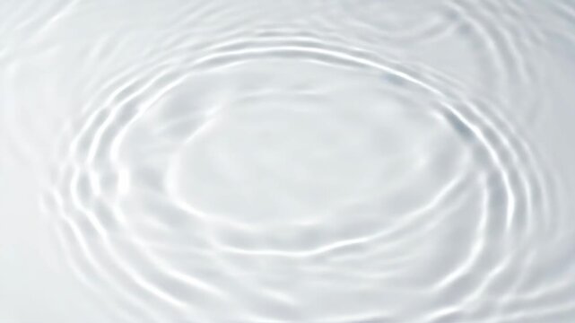 Gentle water ripples spreading across pristine white surface in slow motion. Perfect for wellness branding, skincare visuals, meditation content