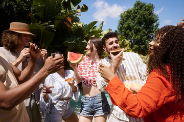 Obraz premium Diverse friends enjoying summer outdoor party with snacks