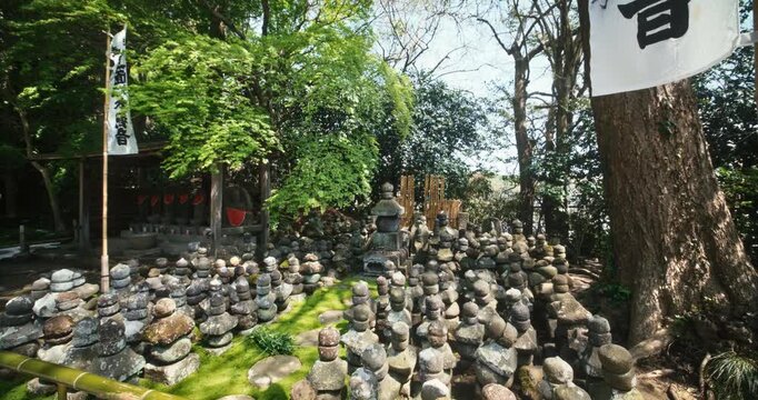 Ancient Stone Jizo Statues Crowded On Moss Ground At Japanese Shrine In Tokyo