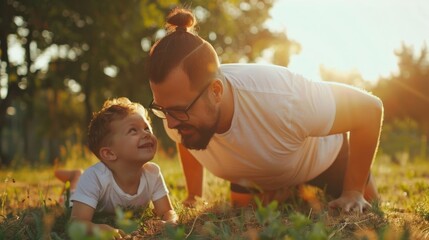 Fototapeta premium A father and his young son enjoy a bonding activity in a sunny park setting The father is in the middle of a push up looking at his smiling child who is lying on the grass