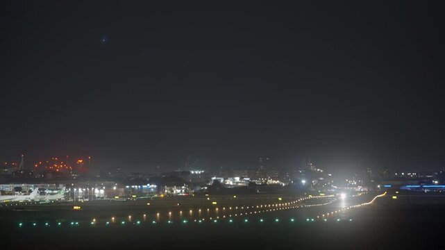 Frontal view of a jet climbing after departure, bright cockpit and landing lights creating glare, colorful indicator lamps visible below