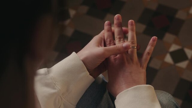 Close-up of a woman taking off her wedding ring from her finger. Symbol of relationship difficulties, breakup, separation. Personal life and family crisis concept. High quality 4k footage