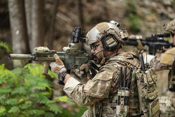 Naklejka premium US Special forces soldiers engaged in combat operation, tactical military team in action
