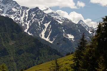 Fototapeta premium Empty Chairlifts Crossing a Summer Mountain Slope