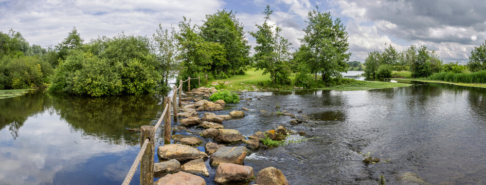 Pedestrian crossing of the Molenplas protected area near Stevensweert, part of the Maas valley river park on the Netherlands Belgium border, designed for water storage and nature restoration
