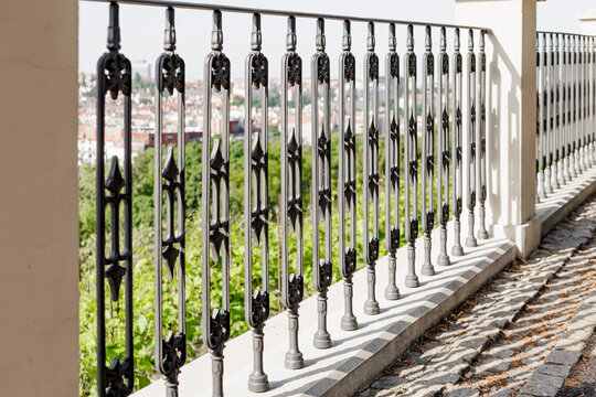 Ornate iron balustrade at grebovka - havlickovy sady - viewpoint in prague, offering decorative metalwork framing city views