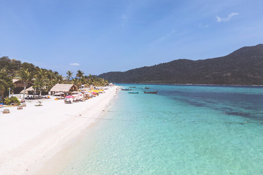 Aerial Drone View of Koh Lipe Island Beach with Turquoise Water and Longtail Boats, Thailand