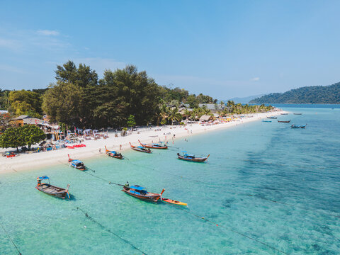 Aerial Drone View of Koh Lipe Island Beach with Turquoise Water and Longtail Boats, Thailand