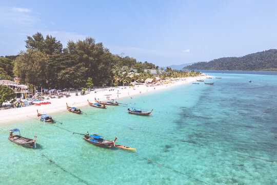 Aerial Drone View of Koh Lipe Island Beach with Turquoise Water and Longtail Boats, Thailand