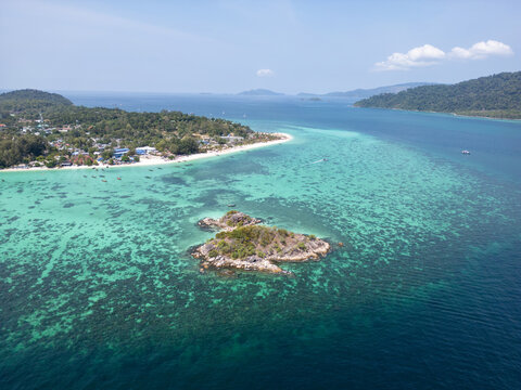 Aerial Drone View of Koh Lipe Island Beach with Turquoise Water and Longtail Boats, Thailand