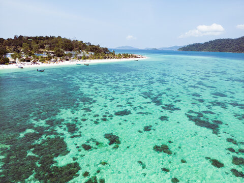 Aerial Drone View of Koh Lipe Island Beach with Turquoise Water and Longtail Boats, Thailand