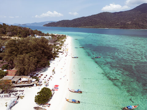 Aerial Drone View of Koh Lipe Island Beach with Turquoise Water and Longtail Boats, Thailand