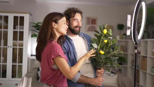 Couple of influence creating content with a lemon tree