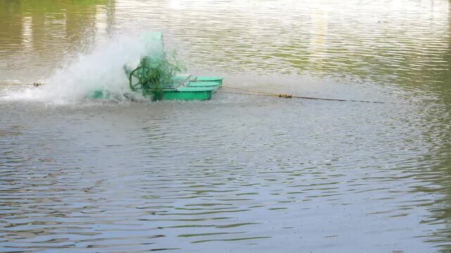 Electric Water Aerator Spinning In Brown Pond Splashing Water