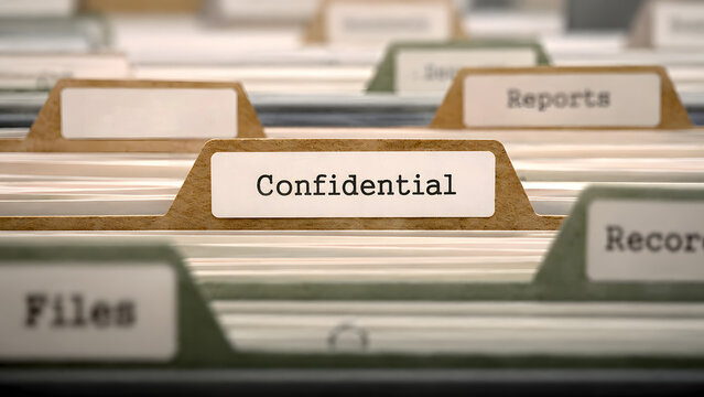 Row of Hanging Manila File Folders with Labels and One Stamped Confidential. Archive System Document Storage and Corporate Database Privacy Concept