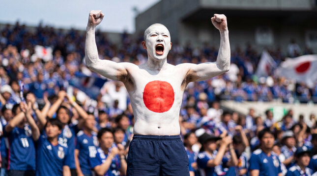 Japanese male fan with body paint celebrating at soccer stadium