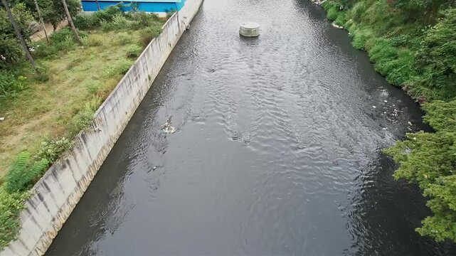 Aerial view shows a Overflowing Drainage Canal with Dirty and Foul Smelling water