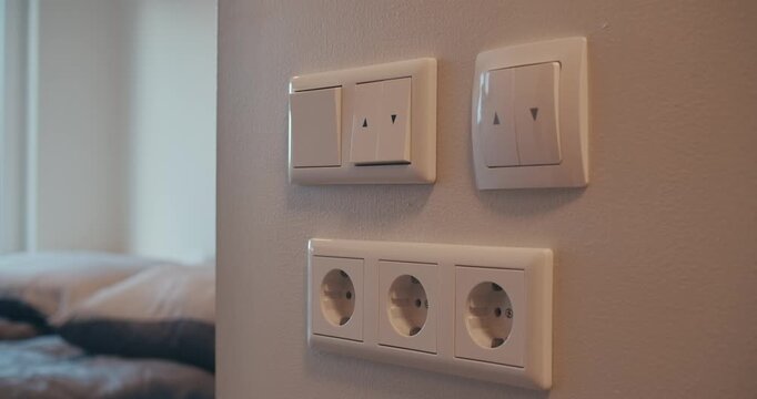 close-up switches man turns off light closes window leaves room and closes door. safety rules When leaving home. storage of electricity heat, saving on costs. techniques for reducing electricity costs