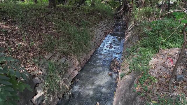 View shows a Overflowing drain Surpassing Debris Filled Area with Stagnant Water