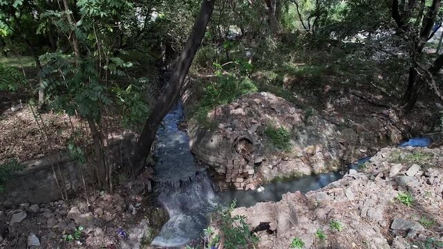 Aerial view shows Overflowing Drain Surpassing Debris Laden Area Stagnant Water