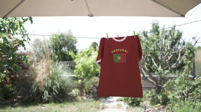 Portuguese soccer fan t-shirt hanging on clothesline
