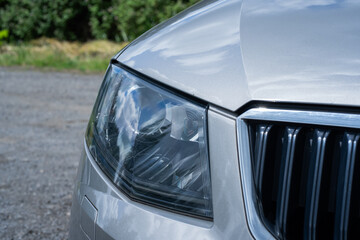 Switched-off xenon headlights on a car showcase modern automotive lighting technology, even when not in use, emphasizing sleek design and advanced equipment. Car dealership catalogs, automotive © Ann