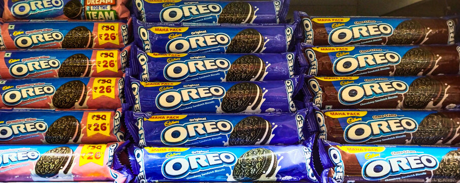 Oreo biscuits. Oreo is an American brand of sandwich cookie consisting of two cocoa biscuits with a sweet fondant filling. Oreos were introduced in 1912 by Nabisco. 