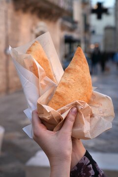 Panzerotti savory pastry, local street food in Bitonto, Italy. Panzerotti with tomato and mozzarella cheese. Smaller type of calzone.
