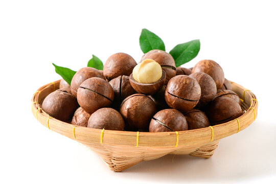 Macadamia Nuts in Bamboo Basket Isolated on White Background