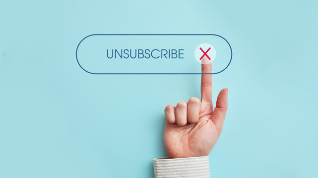Finger pressing unsubscribe button on blue background