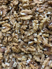Walnut halves closely packed creating a textured natural background for healthy food concepts © dvoevnore