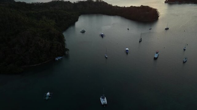 Aerial view of anchored boats floating in a quiet Puerto Galera cove